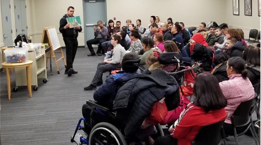 staff member doing a storytime to a large group of people