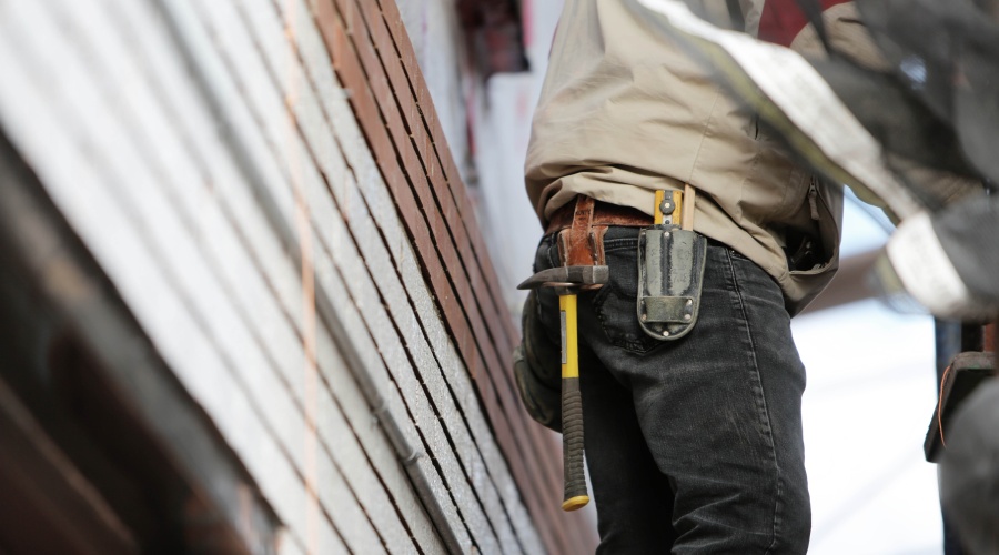 Construction worker with hammer on belt