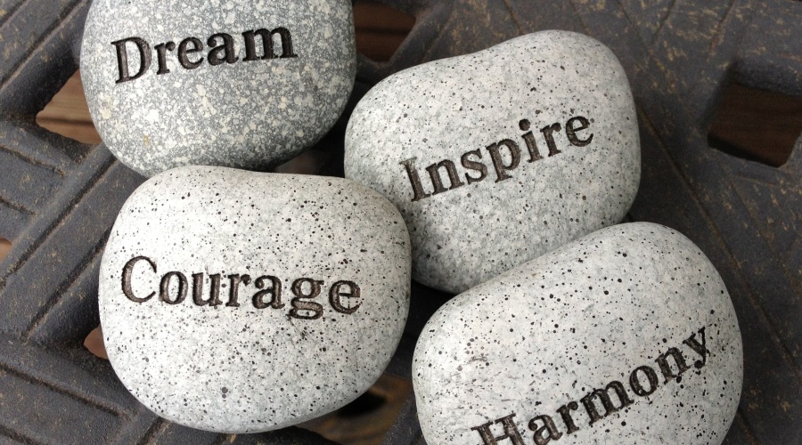 Rocks with words dream, courage, inspire and harmony etched in them