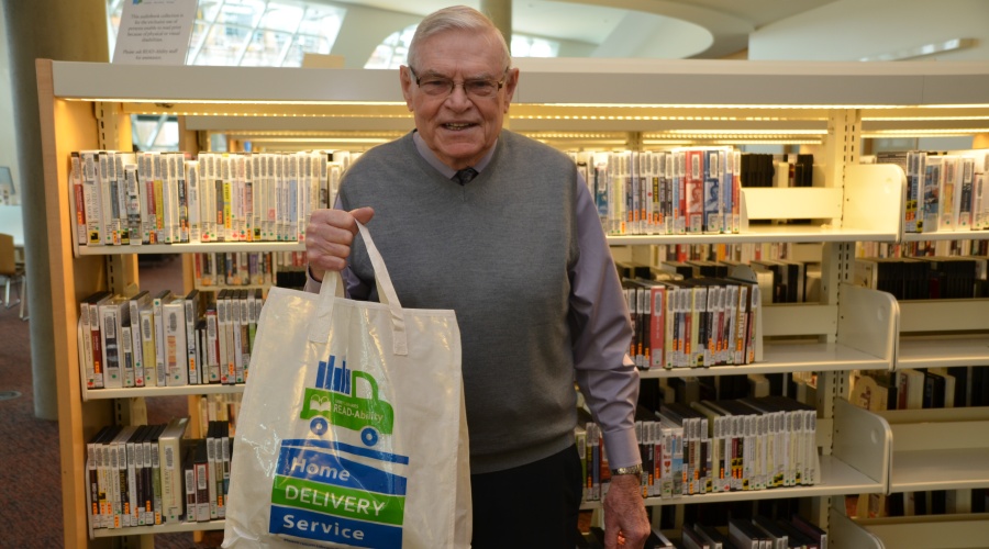 Library home delivery service volunteer with delivery bag