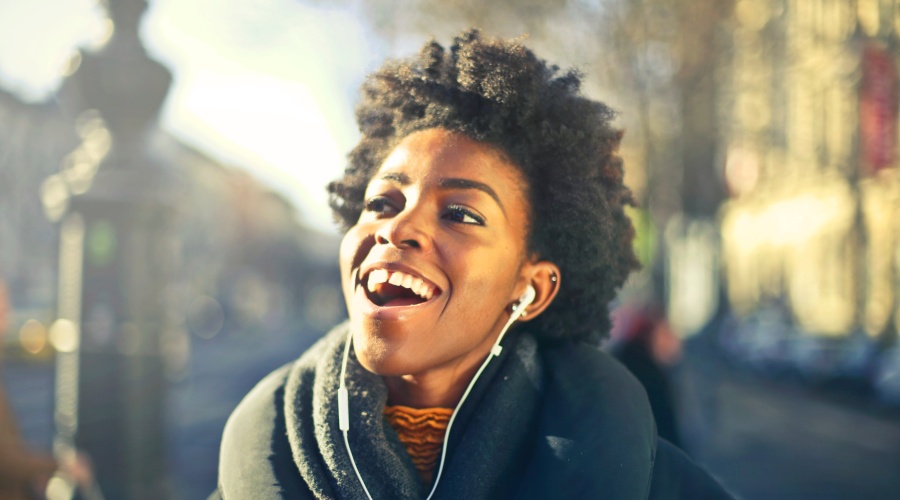 Woman smiling and listening to music with headphones