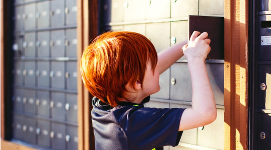 Child opening mail box