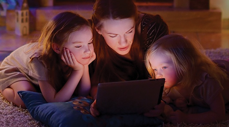 Mom with daughters looking at tablet