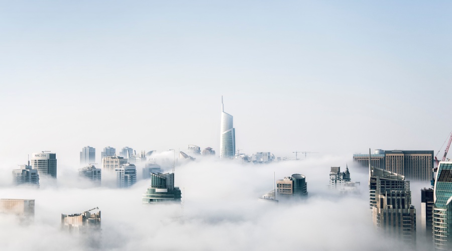 Skyscrapers peaking out of bank of clouds