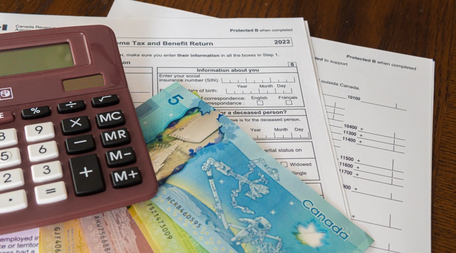 Tax forms with a calculator and some money