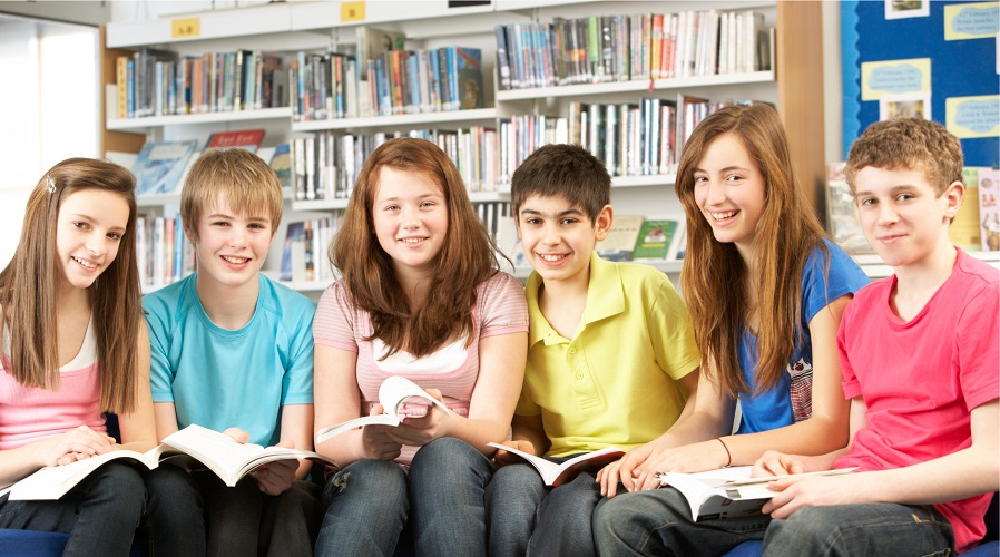 Group of teens in a library setting