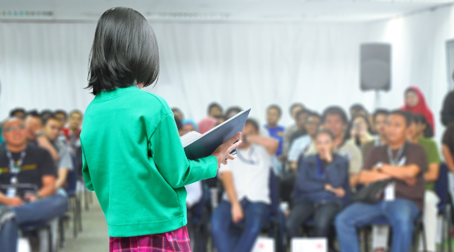 Young women reading to an audience