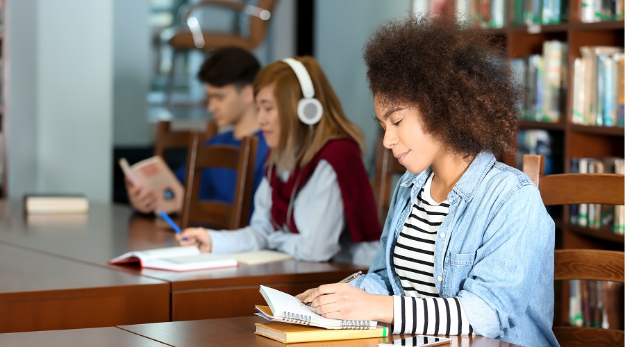 group of teens studying at tables