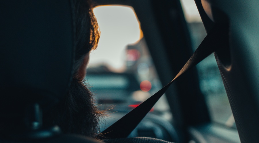 Person riding in a car with seat belt on