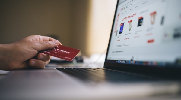 Person with credit card and laptop online shopping