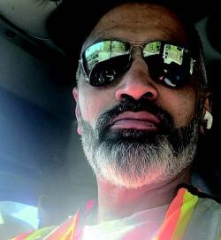 Man with beard wearing sunglasses and a safety vest