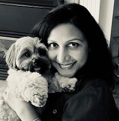 Woman snuggling with small dog