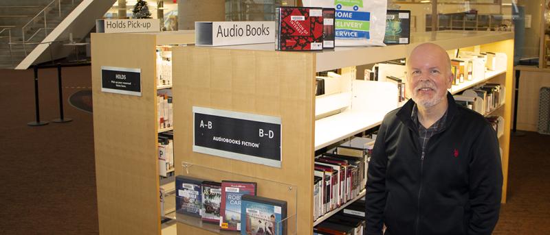 David in front of Shelves