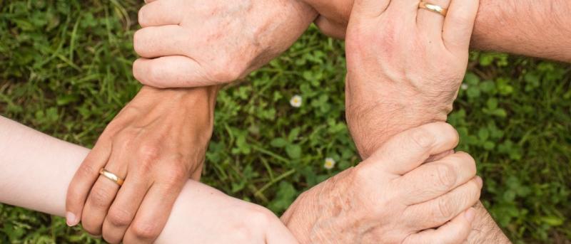 People holding hands to form a loop